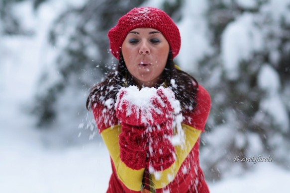 Young woman blowing snow from her hands._edycj_1200x800